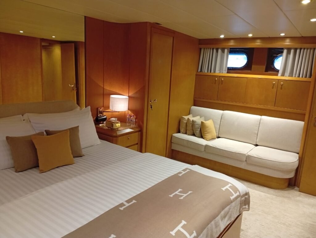 Yacht rental Abu Dhabi | Rent a Yacht Abu Dhabi 75 Raya 88 luxury yacht charter Abu Dhabi – 88-foot premium charter yacht docked at marina with green hull and spacious deck design.